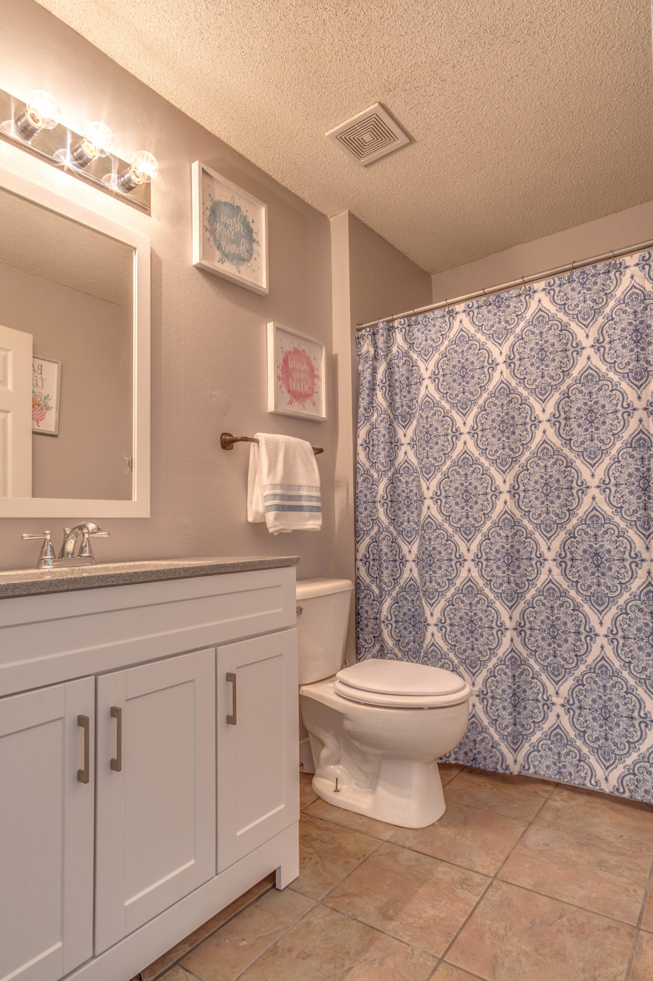 7105 Snug Waters Road Navarre, FL 32566 - Photo 18 of 42 a bathroom with a sink a toilet and a mirror