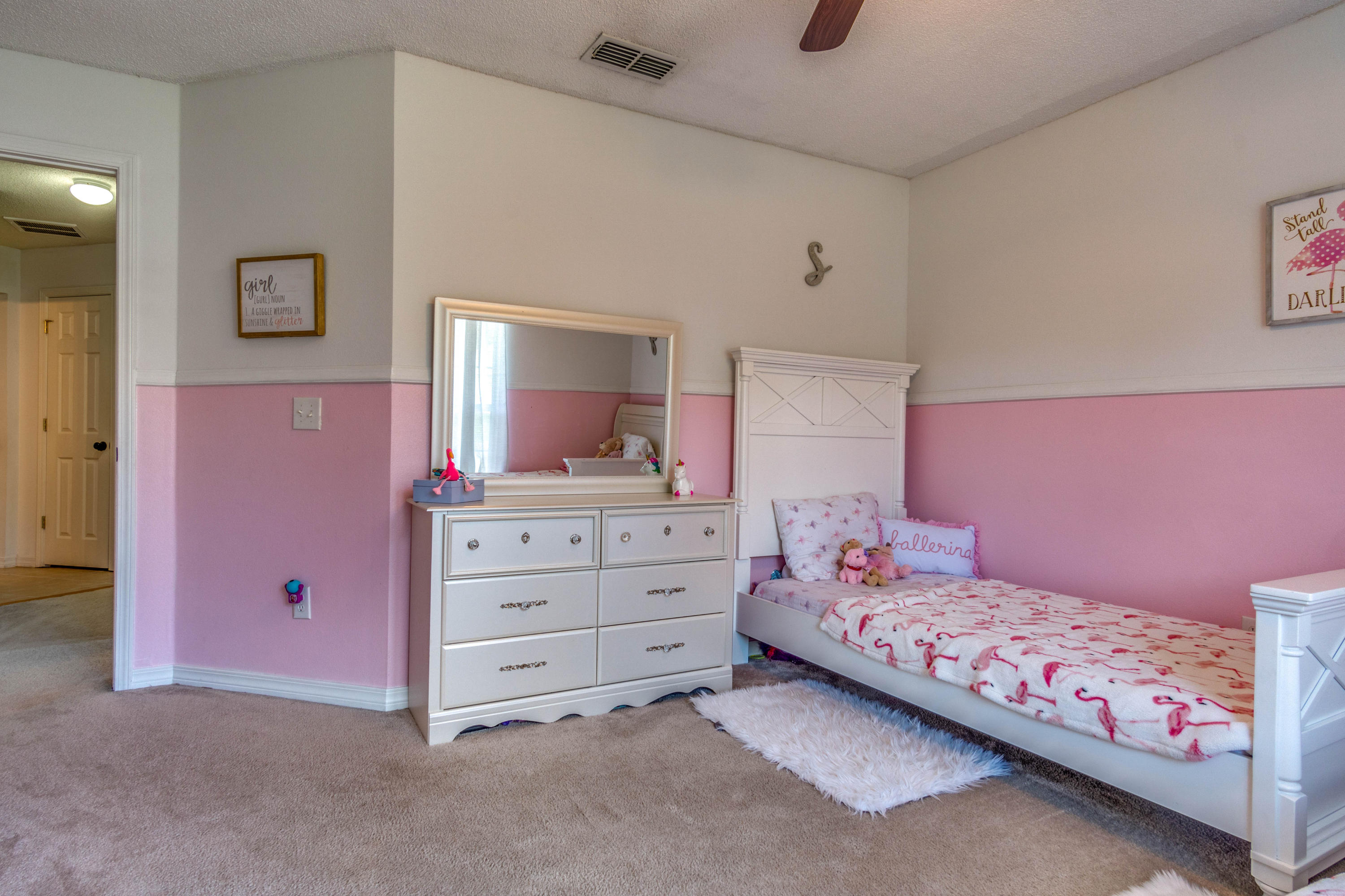 7105 Snug Waters Road Navarre, FL 32566 - Photo 20 of 42 a bedroom with a bed and a flat tv screen on dresser