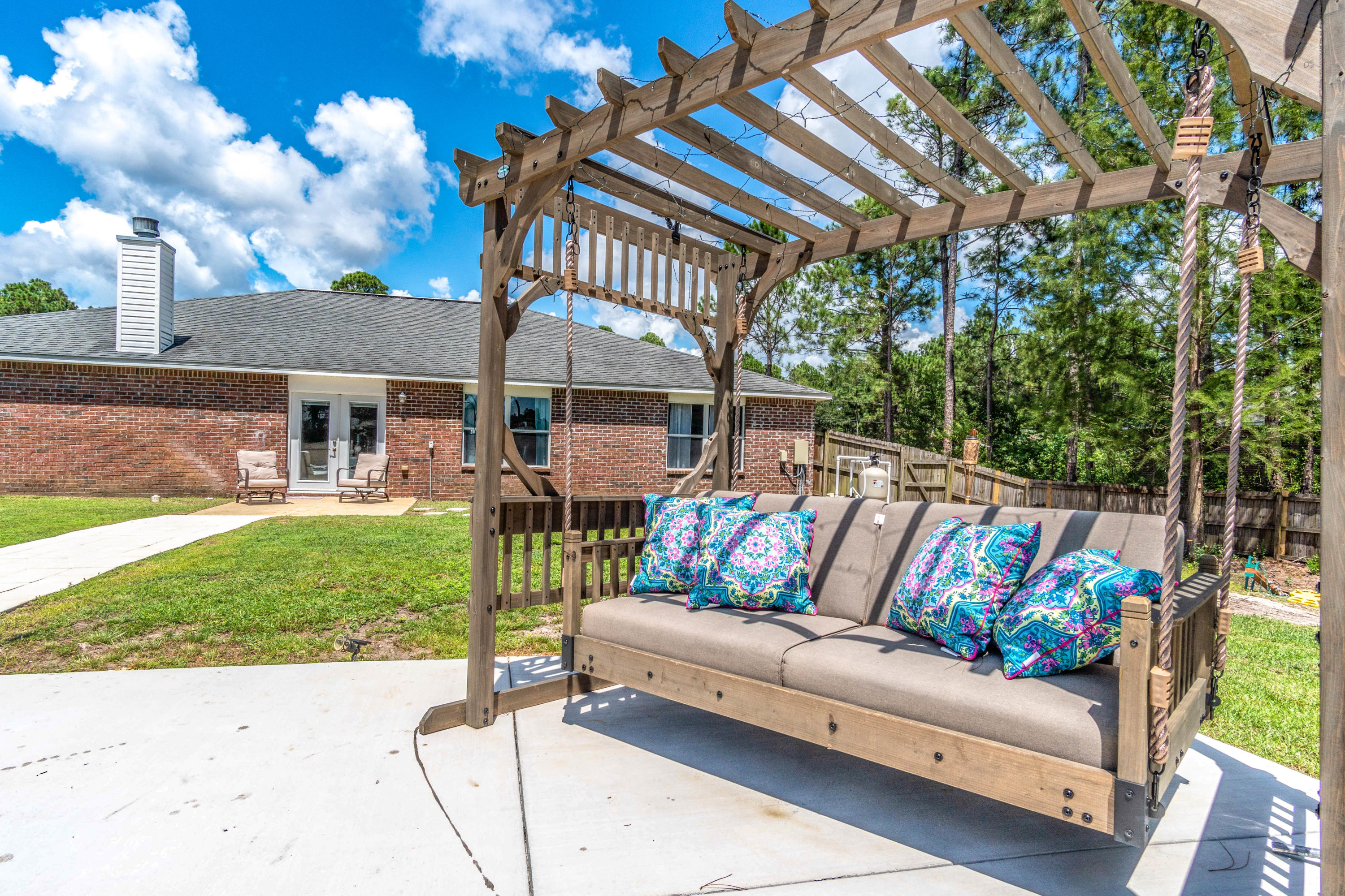 7105 Snug Waters Road Navarre, FL 32566 - Photo 2 of 42 a outdoor living space with furniture and garden view