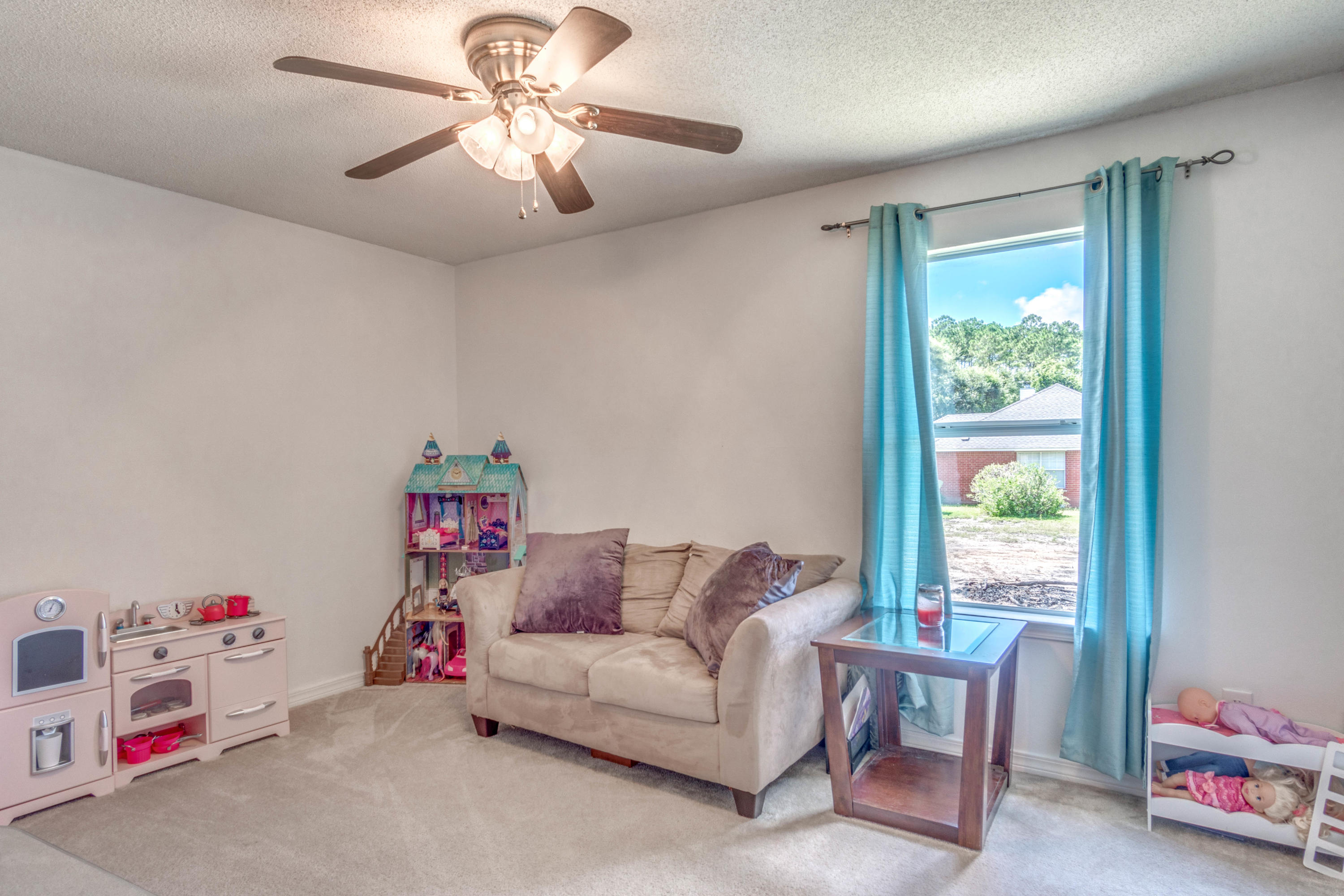 7105 Snug Waters Road Navarre, FL 32566 - Photo 21 of 42 a living room with furniture and a window