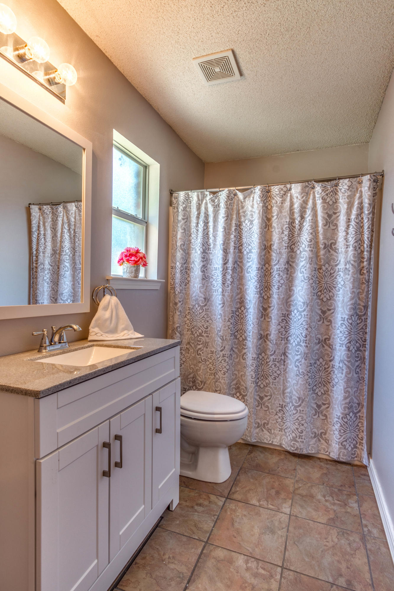 7105 Snug Waters Road Navarre, FL 32566 - Photo 22 of 42 a bathroom with a granite countertop sink and a mirror