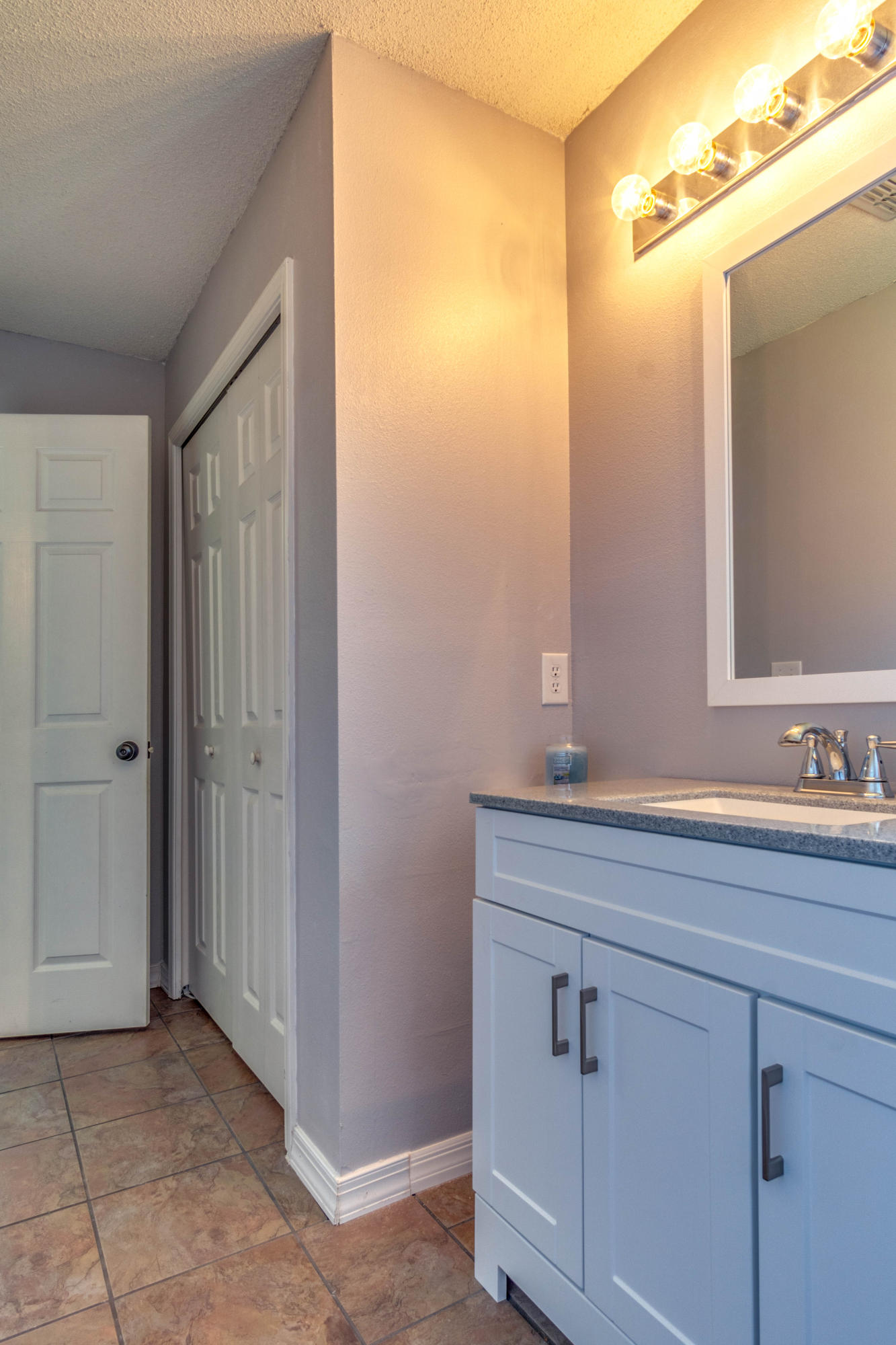7105 Snug Waters Road Navarre, FL 32566 - Photo 23 of 42 a bathroom with a sink and a mirror
