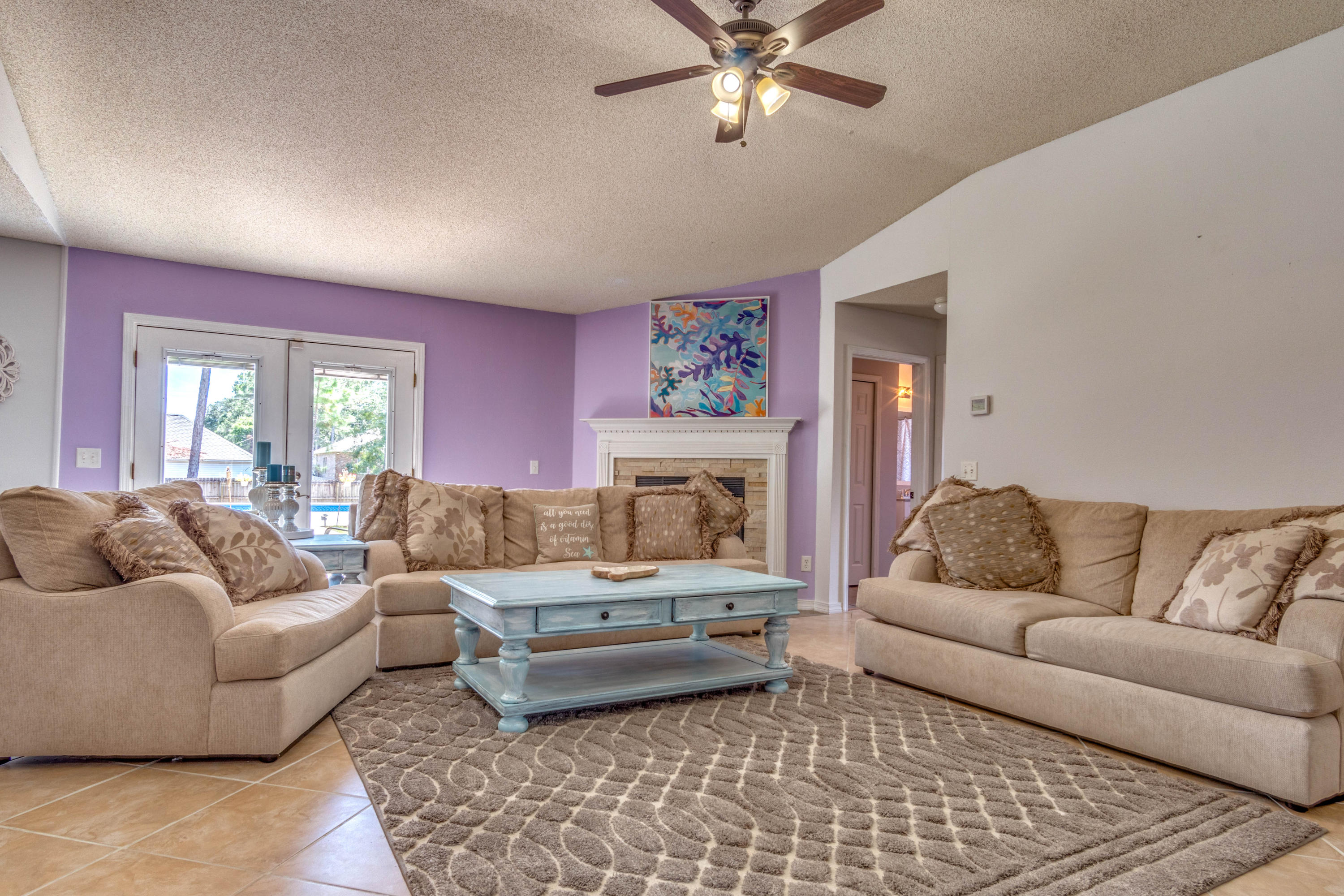7105 Snug Waters Road Navarre, FL 32566 - Photo 25 of 42 a living room with furniture and a fireplace