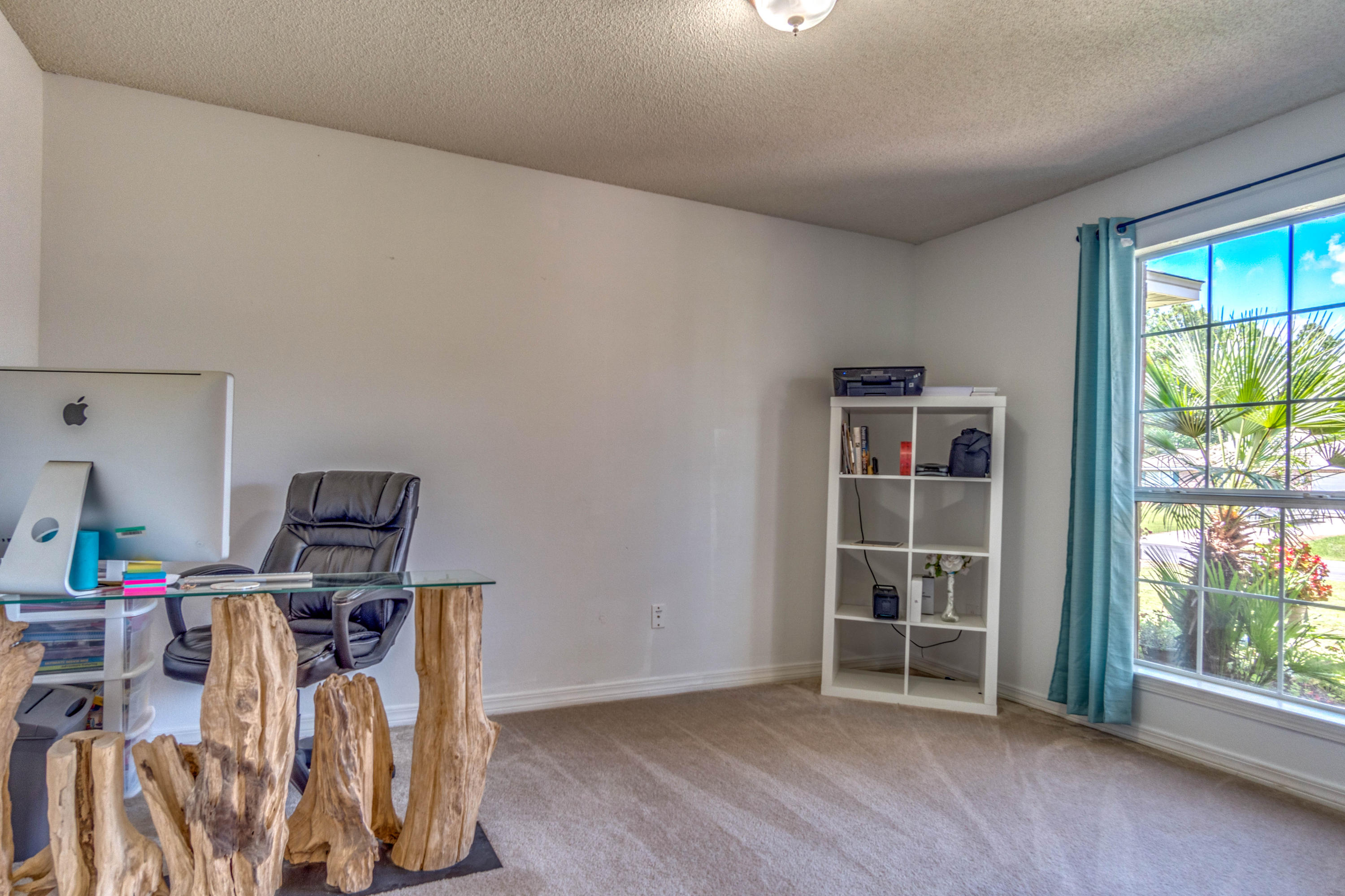 7105 Snug Waters Road Navarre, FL 32566 - Photo 28 of 42 a view of a workspace with furniture and a window