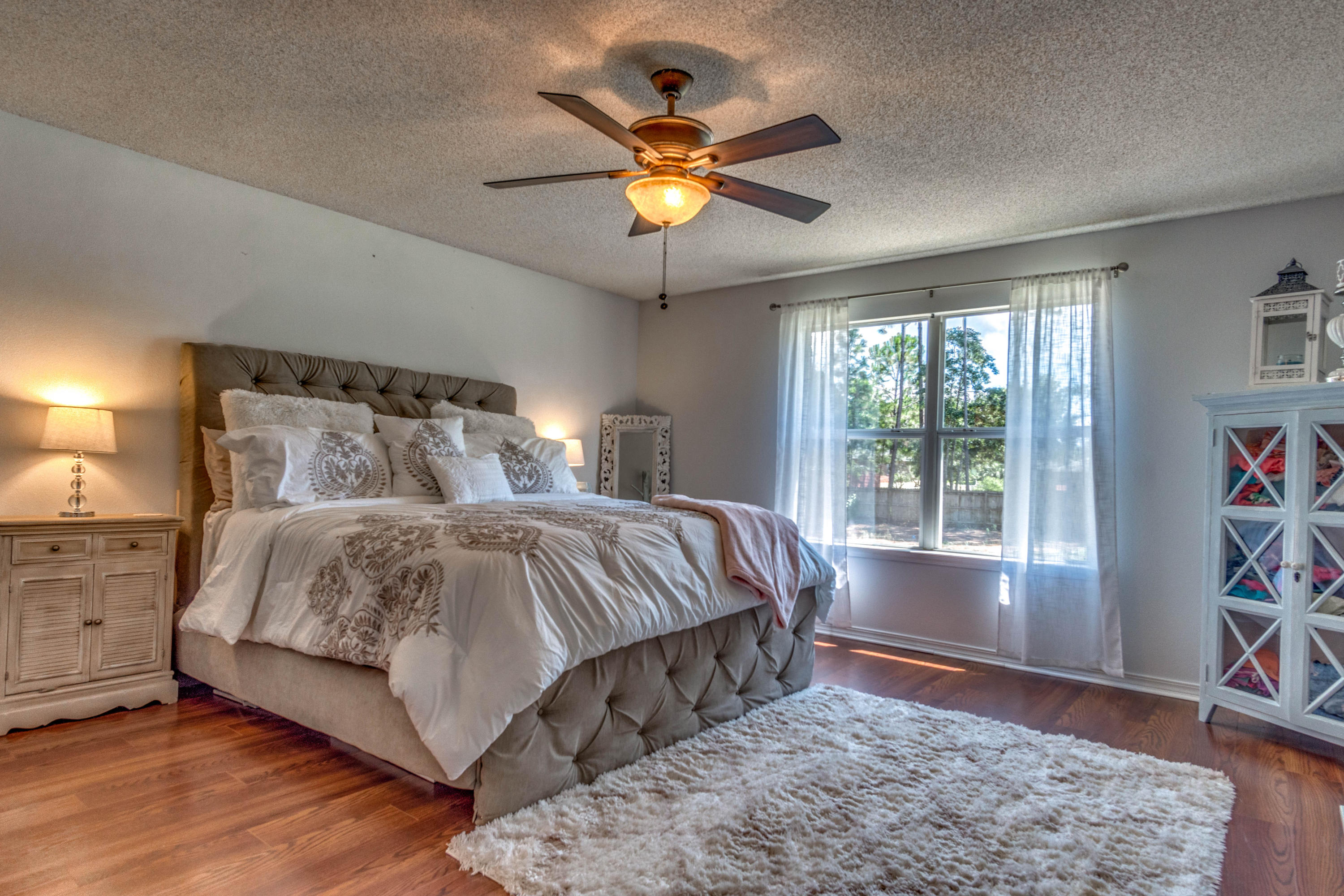 7105 Snug Waters Road Navarre, FL 32566 - Photo 30 of 42 a bedroom with a bed and window