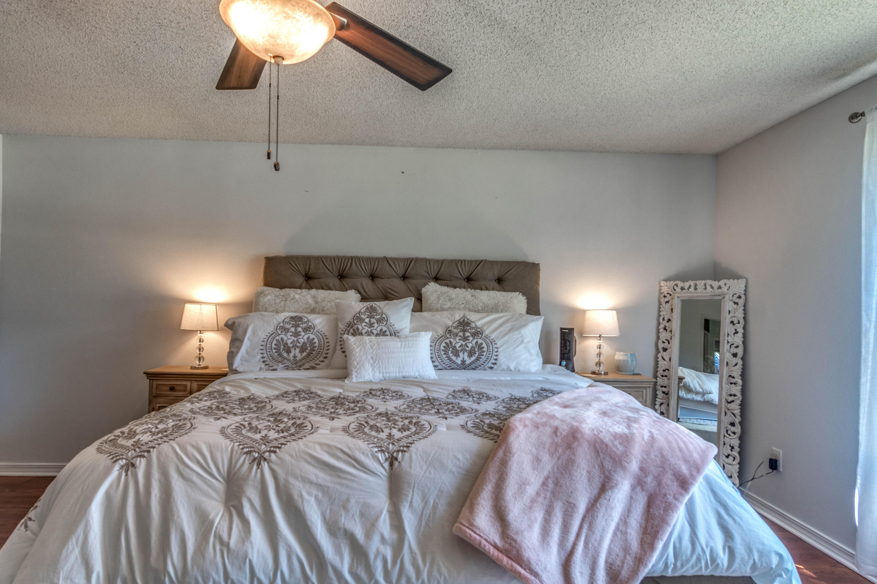 7105 Snug Waters Road Navarre, FL 32566 - Photo 32 of 42 a bedroom with a bed and a chandelier