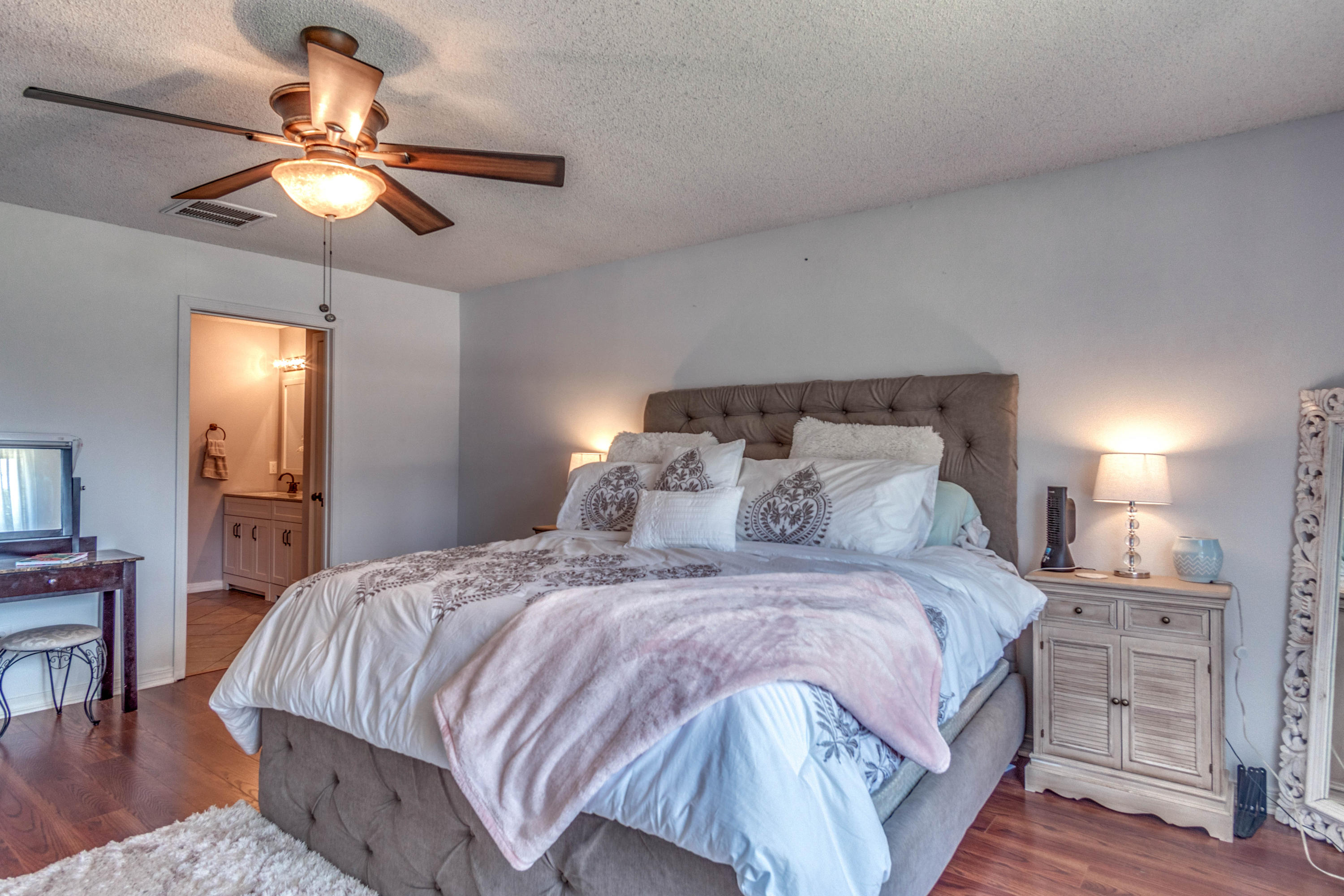 7105 Snug Waters Road Navarre, FL 32566 - Photo 33 of 42 a bedroom with a bed and a chandelier