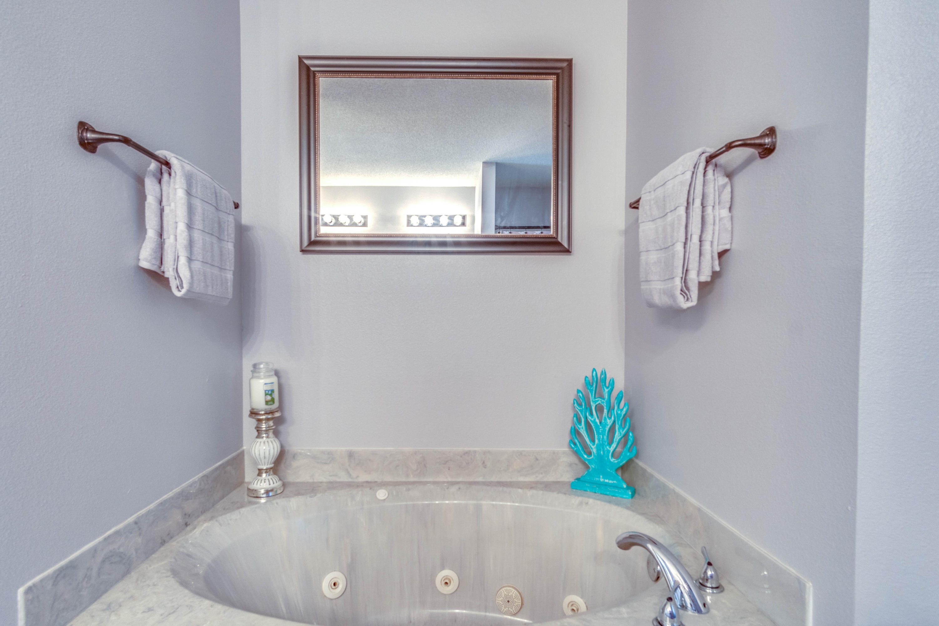 7105 Snug Waters Road Navarre, FL 32566 - Photo 35 of 42 a bathroom with a bathtub