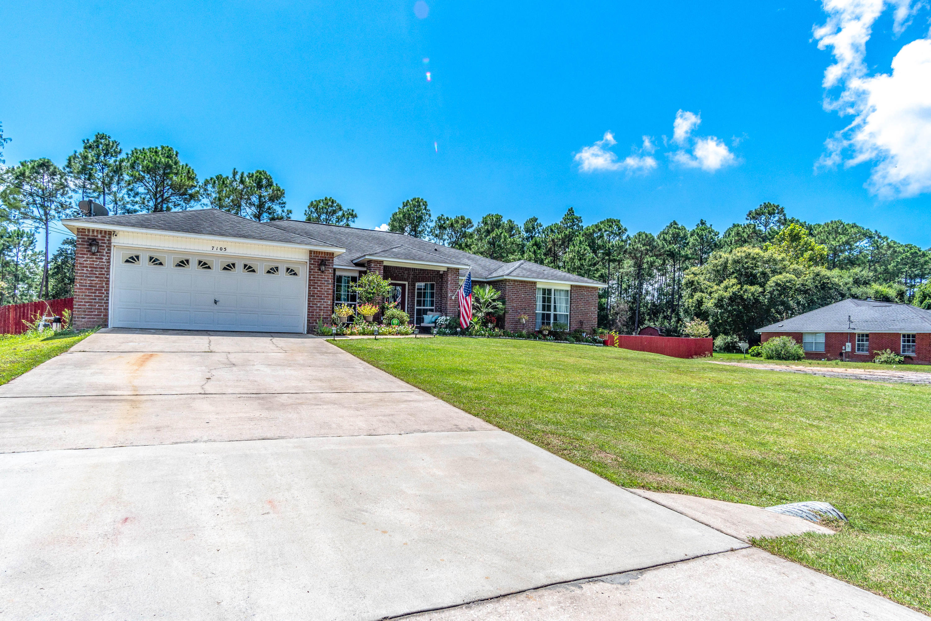 7105 Snug Waters Road Navarre, FL 32566 - Photo 37 of 42 a view of house with outdoor space and garden