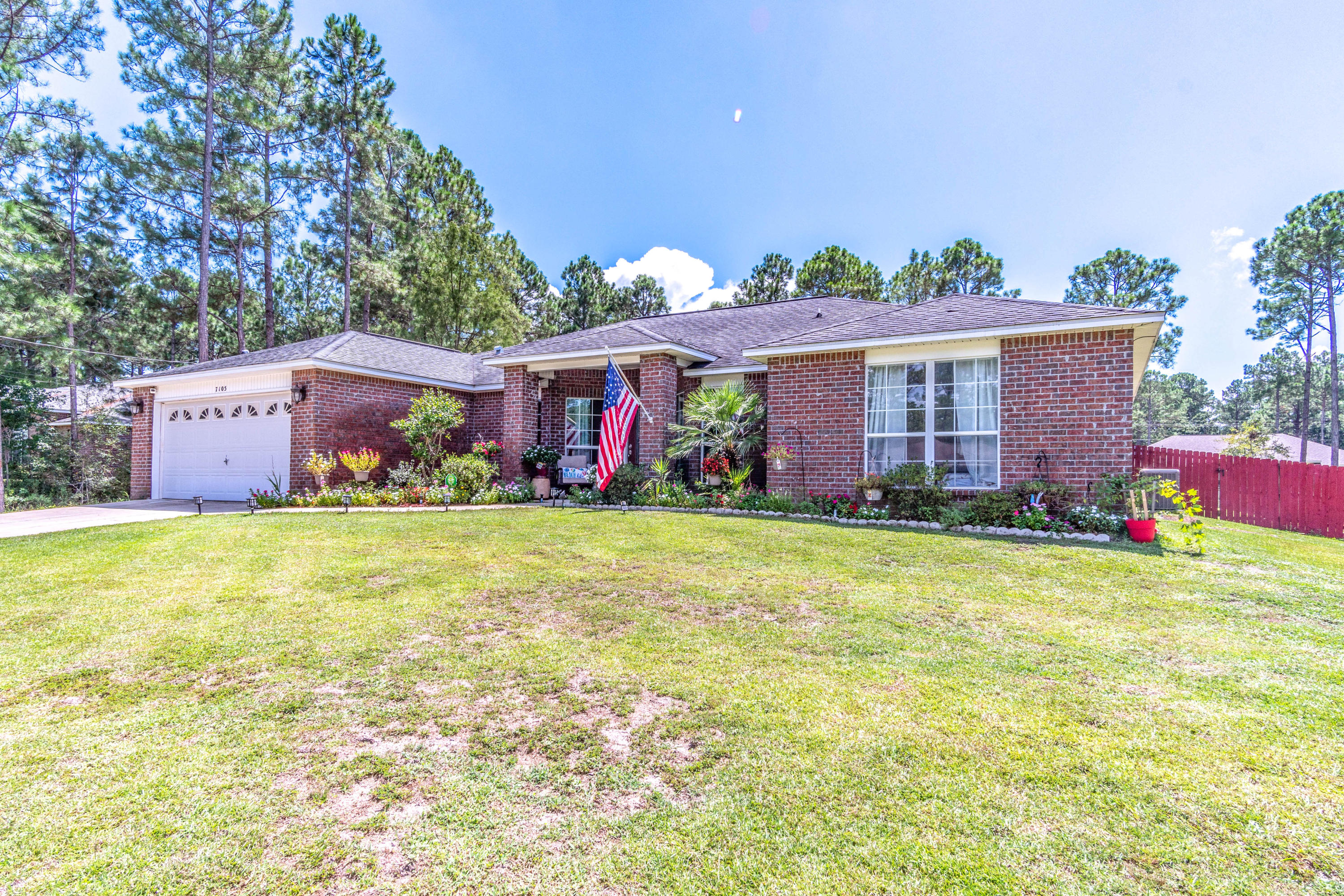 7105 Snug Waters Road Navarre, FL 32566 - Photo 39 of 42 a front view of house with an outdoor space and seating