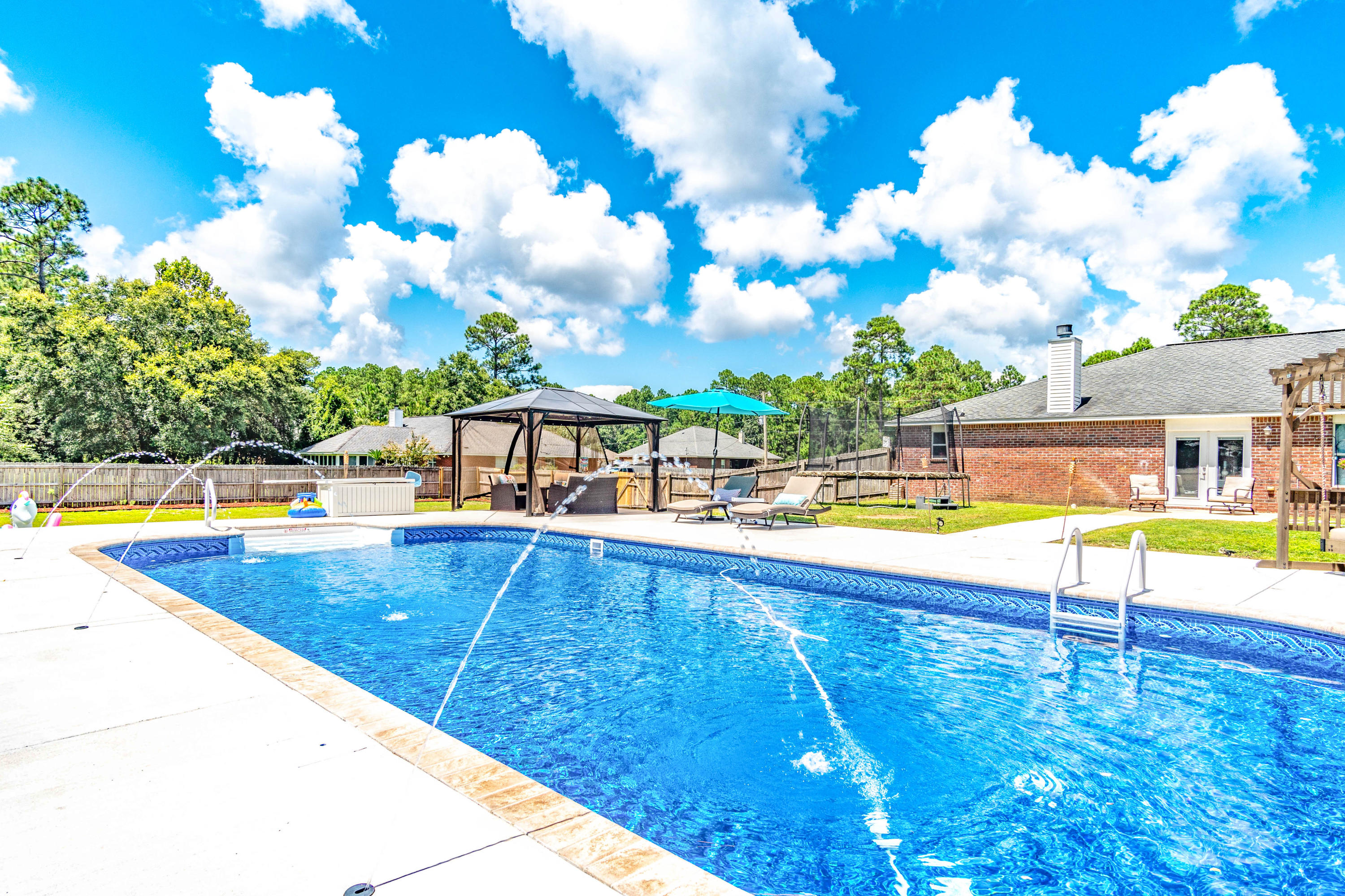 7105 Snug Waters Road Navarre, FL 32566 - Photo 42 of 42 swimming pool with outdoor seating