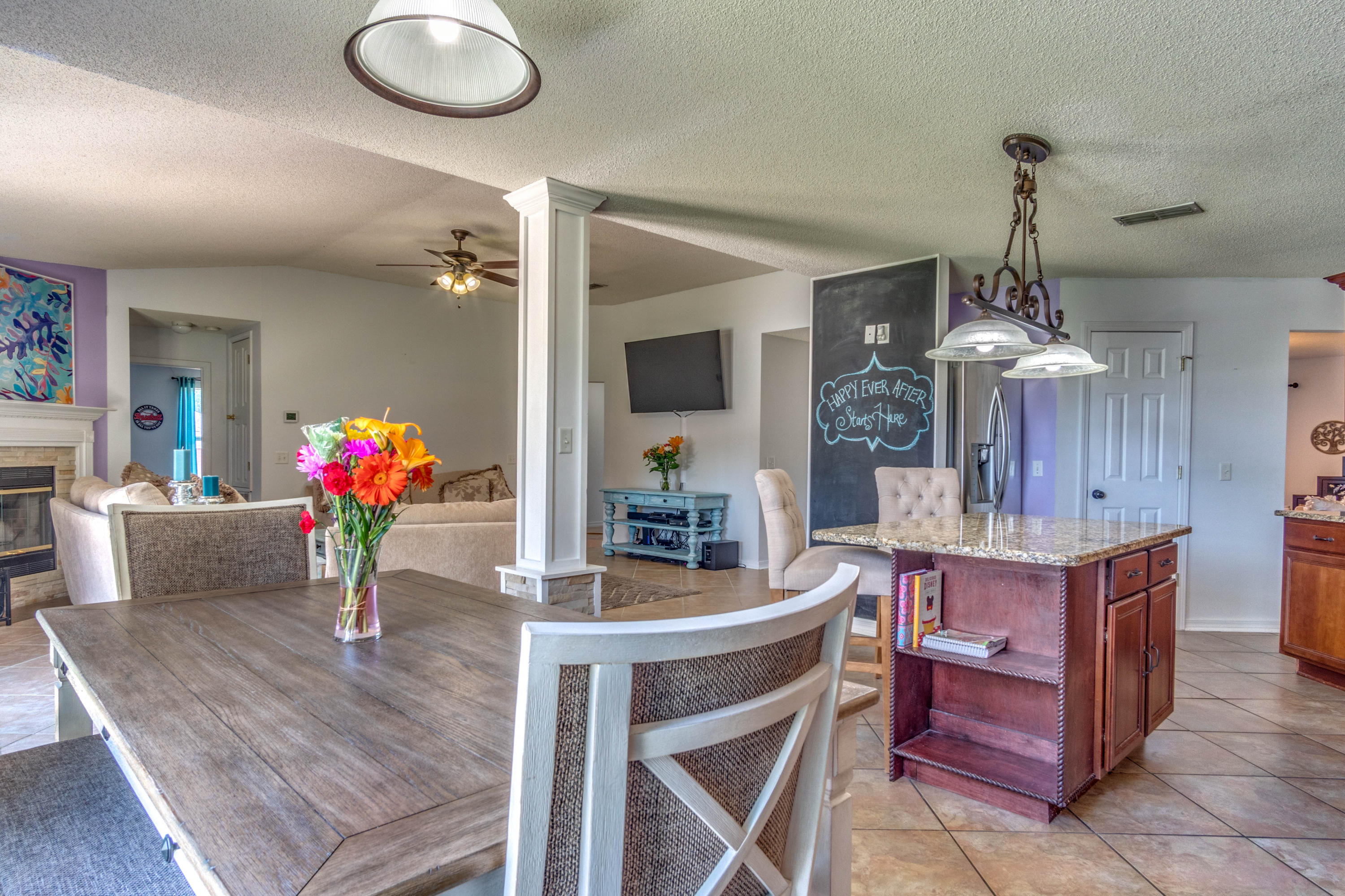 7105 Snug Waters Road Navarre, FL 32566 - Photo 10 of 42 a view of a dining room with furniture and a chandelier
