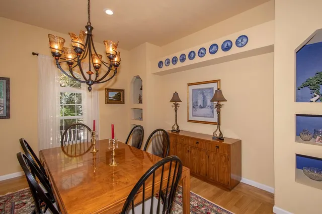 a view of a dining room with furniture and chandelier