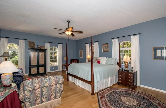 a bed sitting in a bedroom next to a window