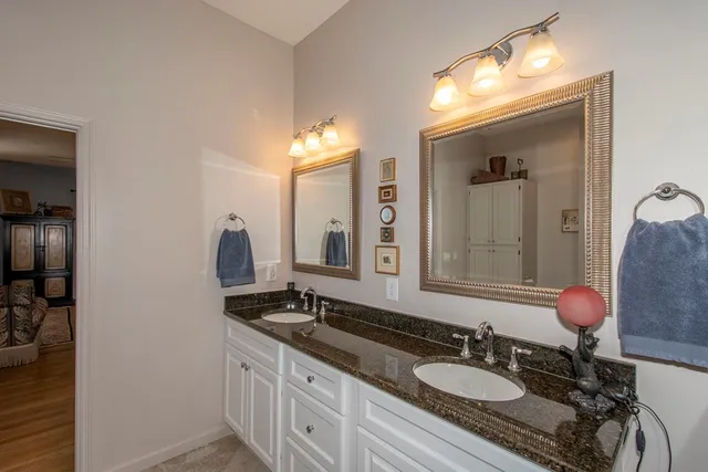 a bathroom with a sink double vanity and a mirror