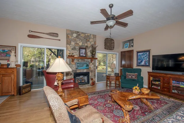 a living room with furniture a fireplace and a flat screen tv