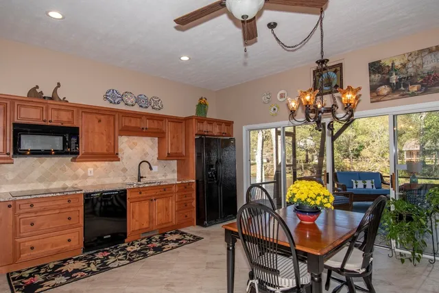 a kitchen with a table chairs and a chandelier