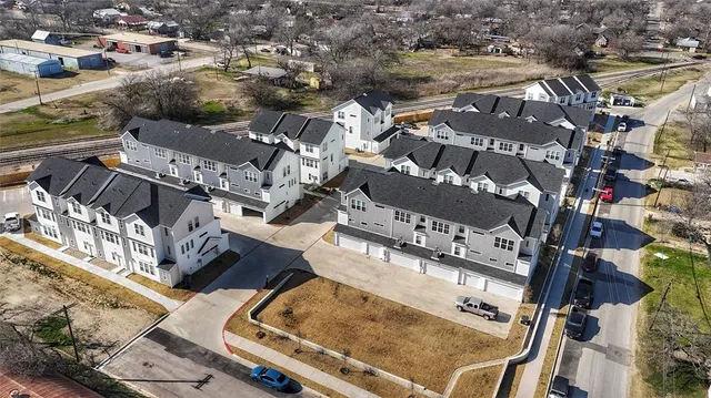 an aerial view of residential houses with outdoor space
