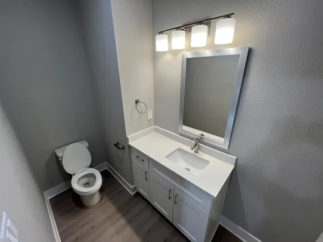 a bathroom with a sink mirror and vanity