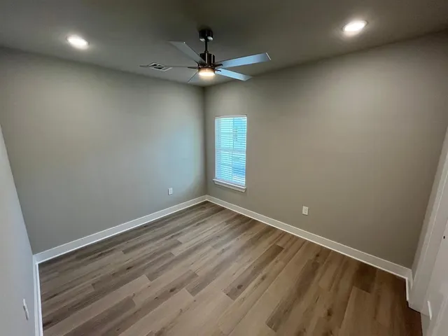 wooden floor in an empty room with a window