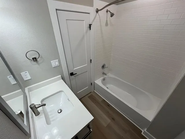 a bathroom with a tub and shower