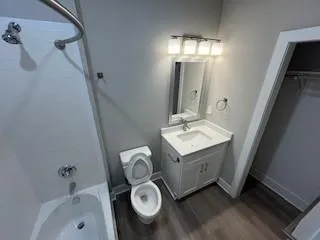 a view of staircase with white walls and white door