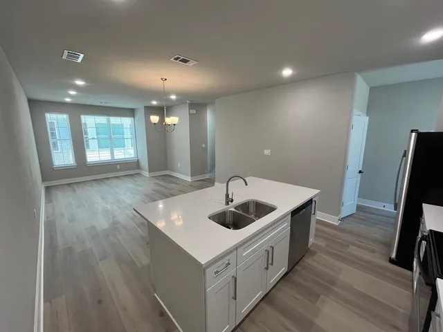 a kitchen with sink and refrigerator