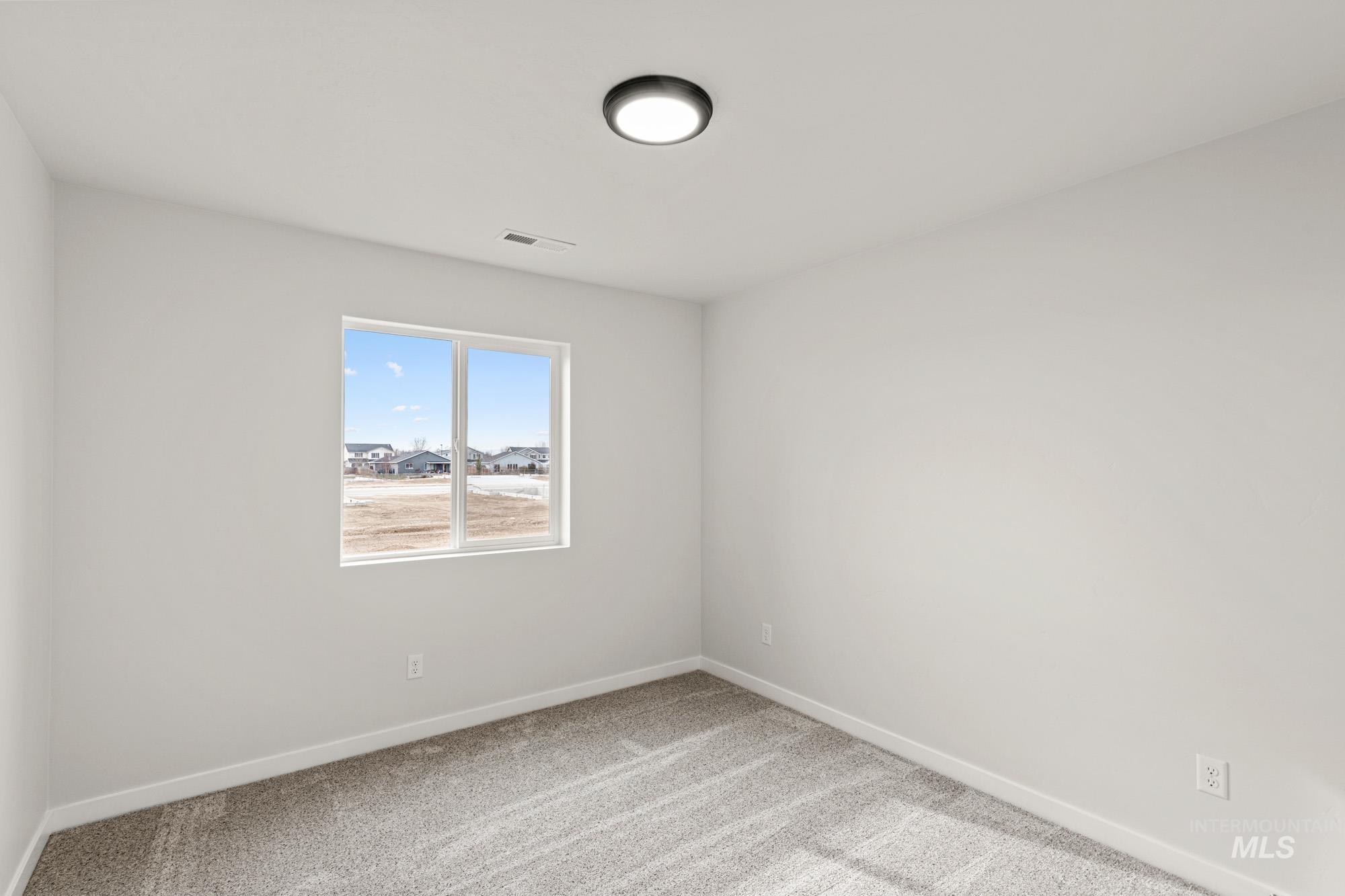 1533 Long Pond Street Middleton, ID 83644 - Photo 11 of 21 Empty room with light carpet and baseboards