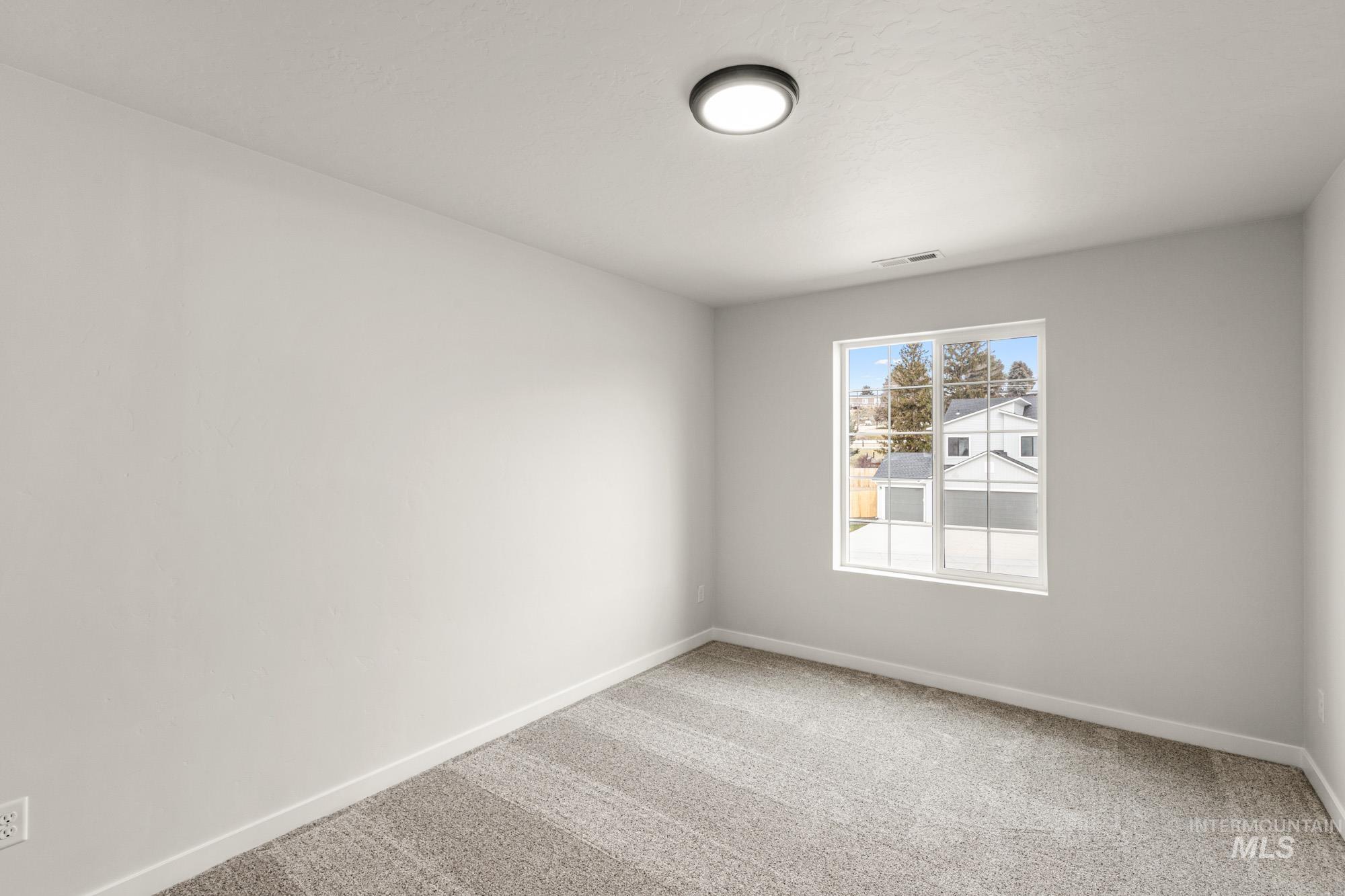1533 Long Pond Street Middleton, ID 83644 - Photo 13 of 21 Unfurnished room with light carpet and baseboards
