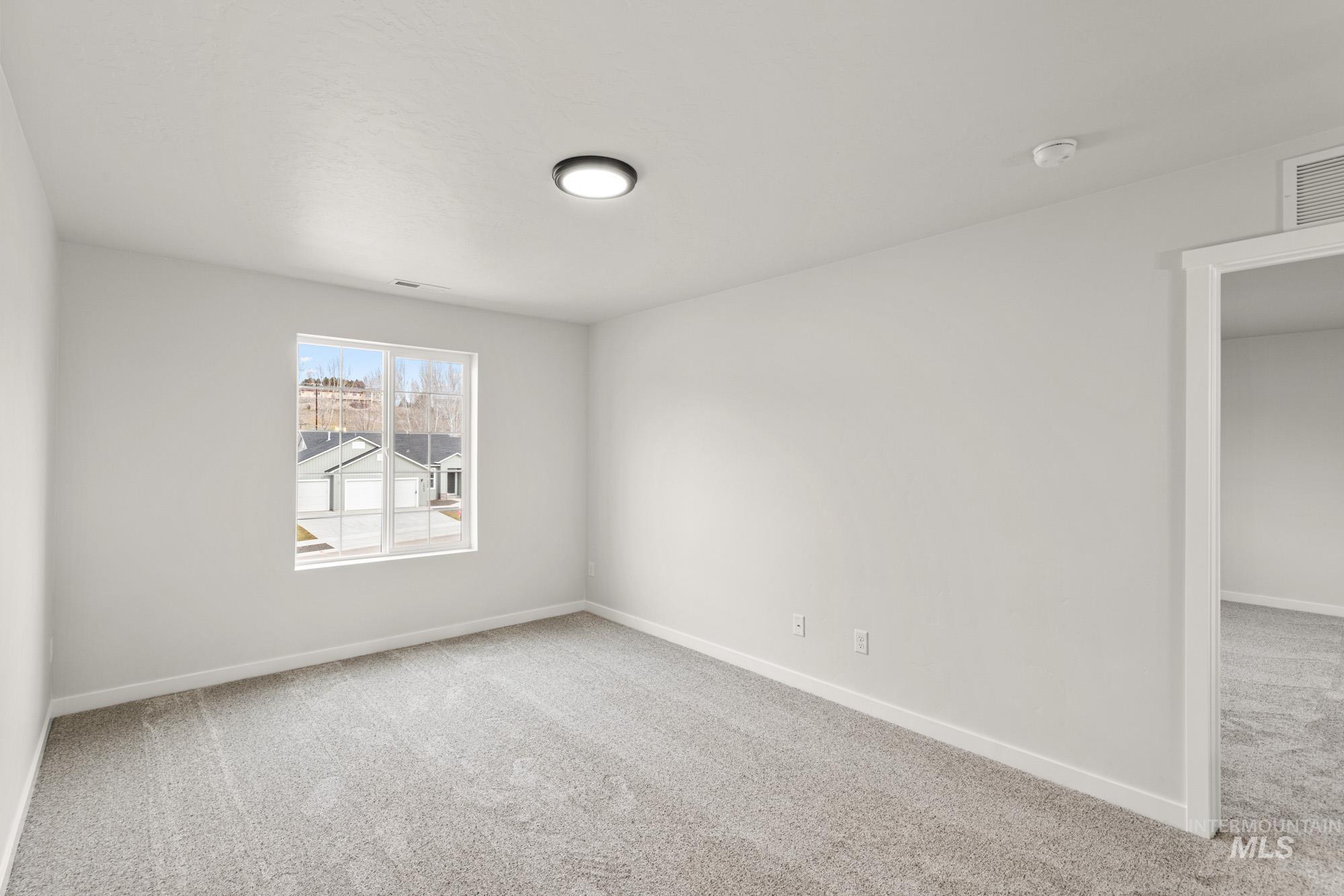 1533 Long Pond Street Middleton, ID 83644 - Photo 14 of 21 Unfurnished room with light colored carpet and baseboards