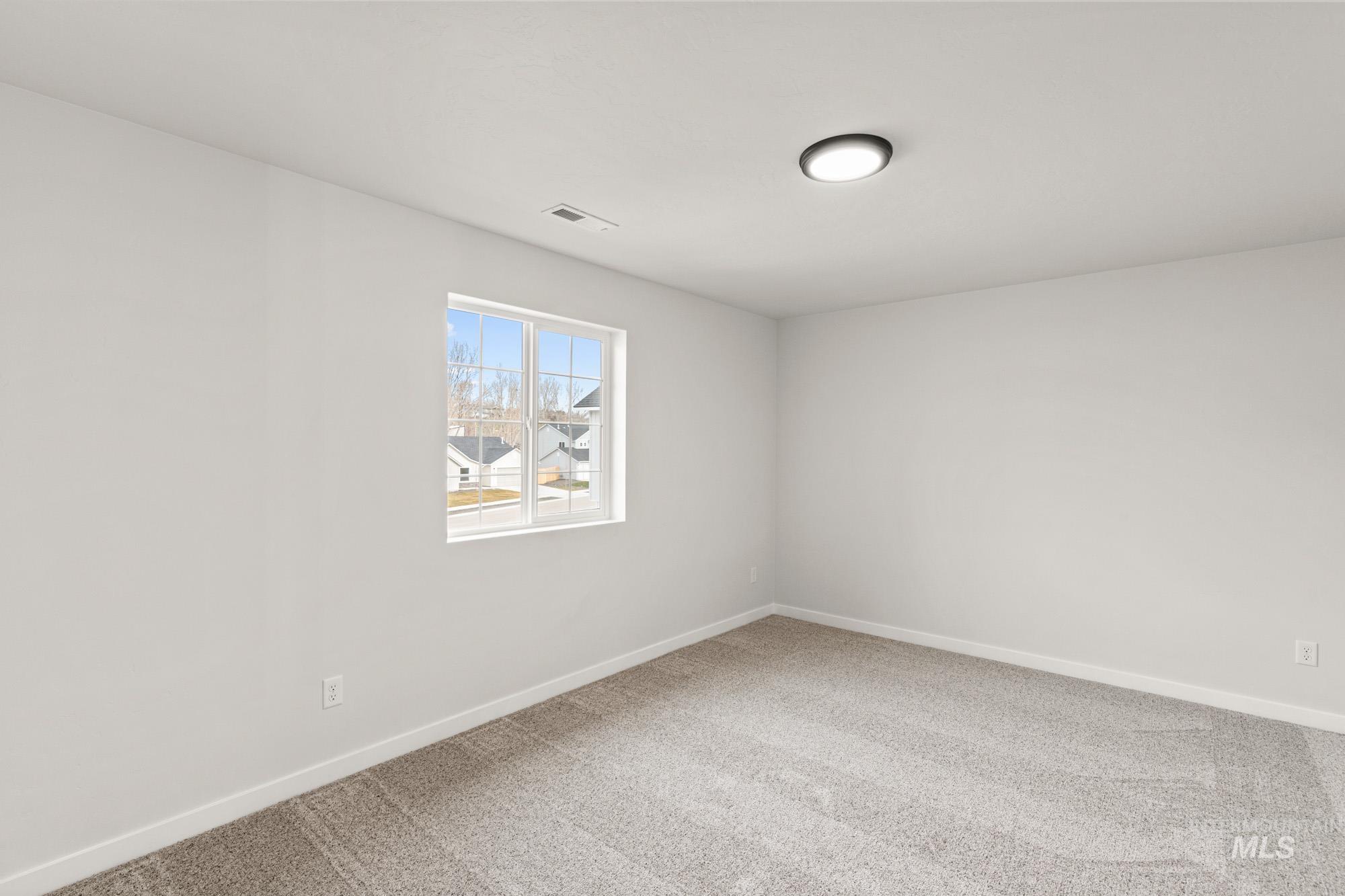 1533 Long Pond Street Middleton, ID 83644 - Photo 15 of 21 Empty room with light carpet and baseboards