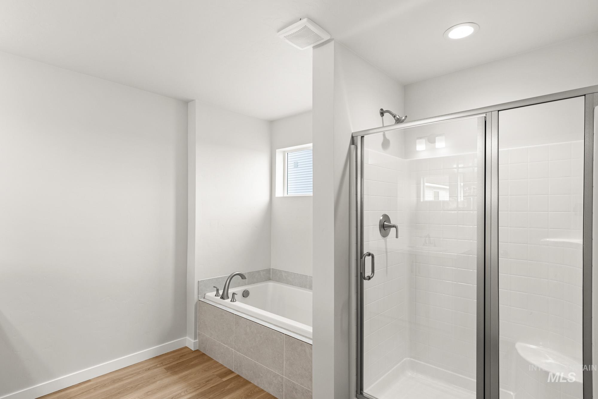 1533 Long Pond Street Middleton, ID 83644 - Photo 17 of 21 Bathroom with light wood-type flooring, a shower stall, and a garden tub