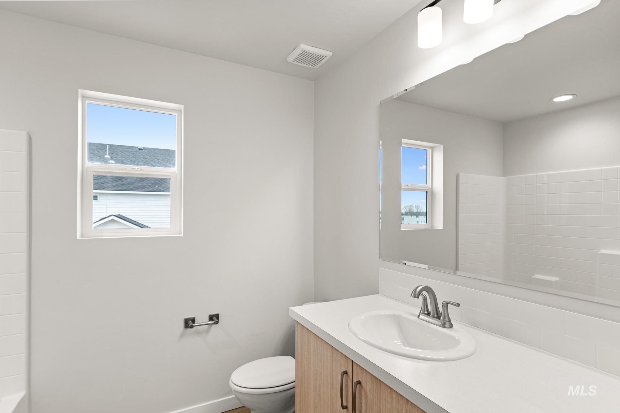 1533 Long Pond Street Middleton, ID 83644 - Photo 20 of 21 Bathroom with vanity, healthy amount of natural light, and shower / bath combination