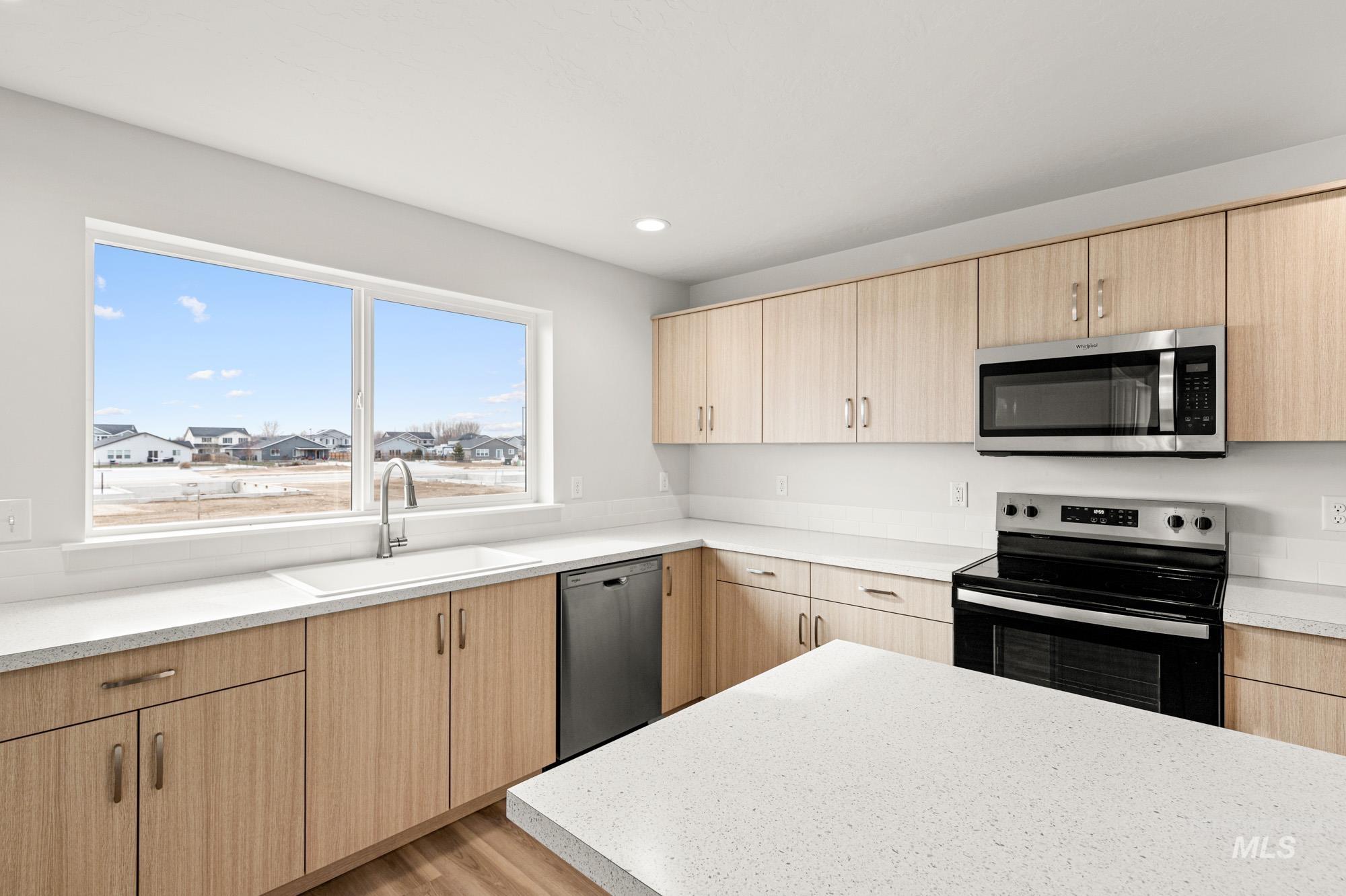 1533 Long Pond Street Middleton, ID 83644 - Photo 6 of 21 Kitchen featuring light wood finish cabinetry, stainless steel appliances, light wood finished floors, modern cabinets, and recessed lighting