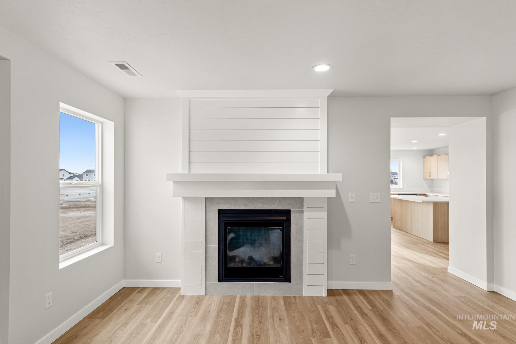 1533 Long Pond Street Middleton, ID 83644 - Photo 9 of 21 Detailed view of wood finished floors, a tile fireplace, and recessed lighting