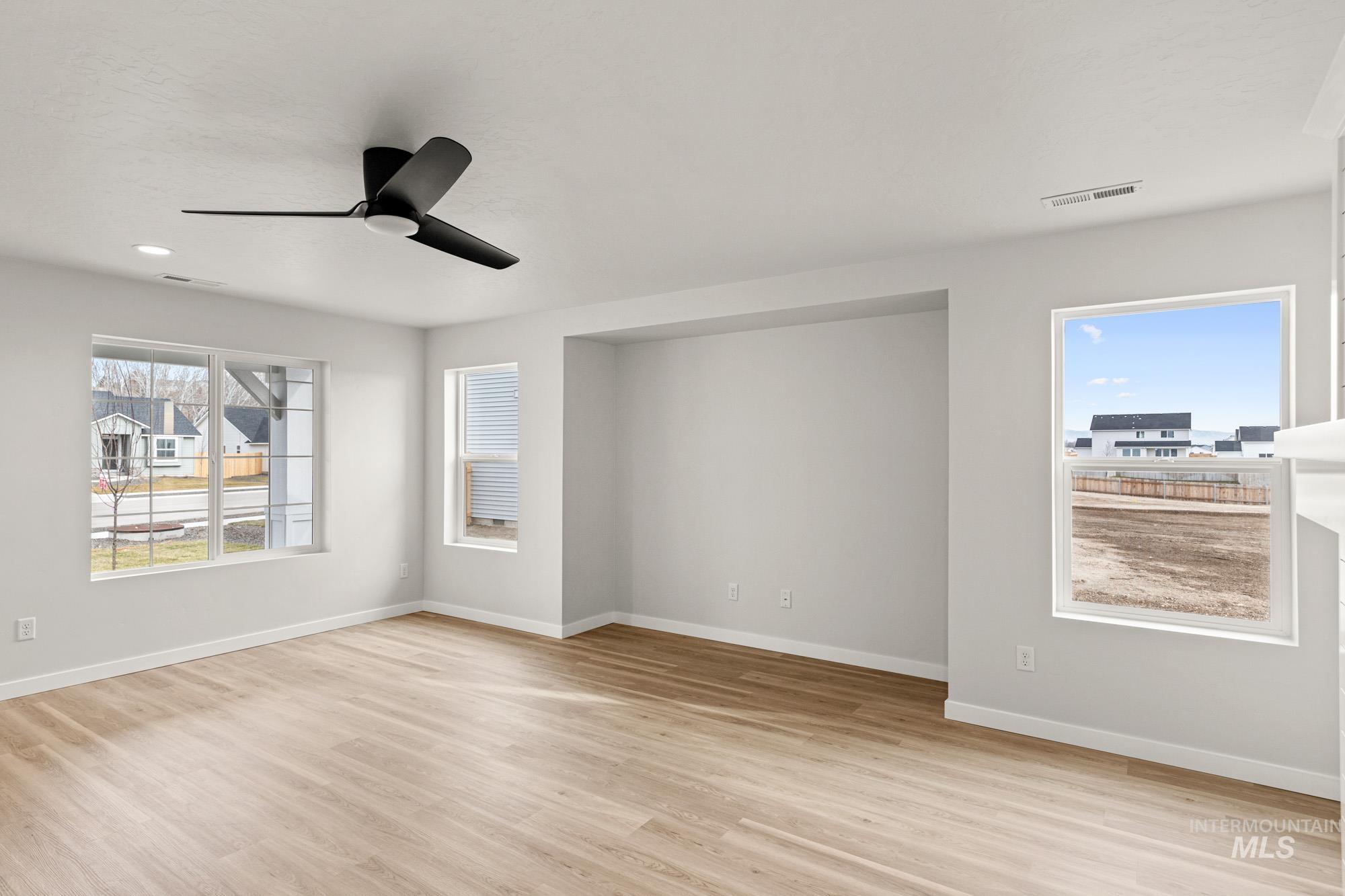 1533 Long Pond Street Middleton, ID 83644 - Photo 10 of 21 Unfurnished room featuring a ceiling fan, light wood-style floors, and recessed lighting