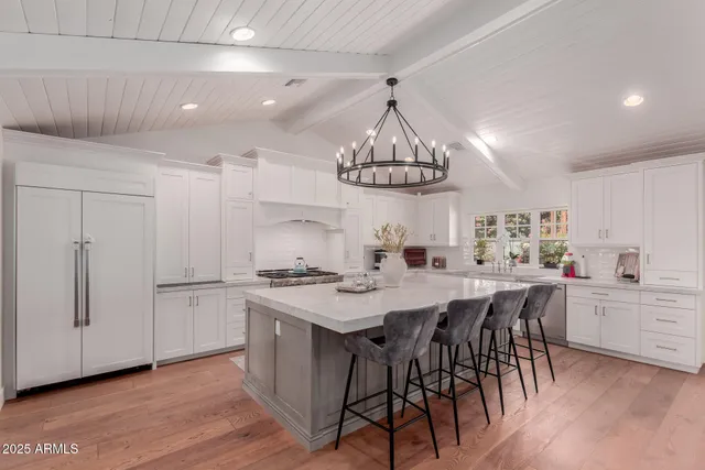 a view of a dining room with furniture wooden floor and chandelier