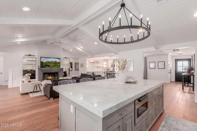 a kitchen with stainless steel appliances granite countertop a stove and a wooden floors