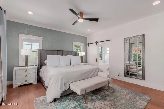 a bedroom with a bed and a window