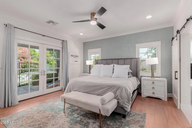 a bedroom with a bed and a large window