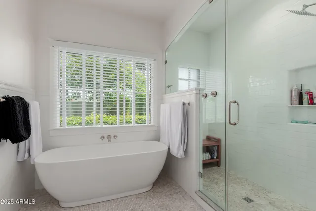 a bathroom with a bathtub and a shower