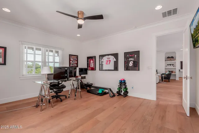 a view of a livingroom with workspace and a window
