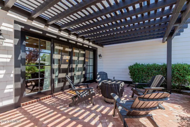 a view of house with a yard and sitting area