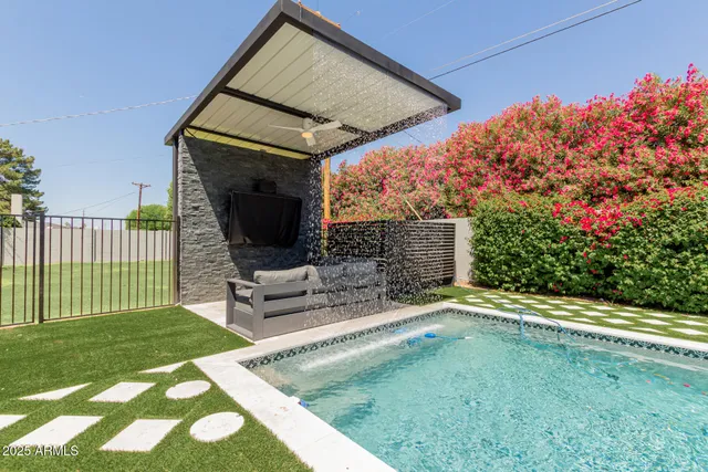 a view of a house with a yard and potted plants