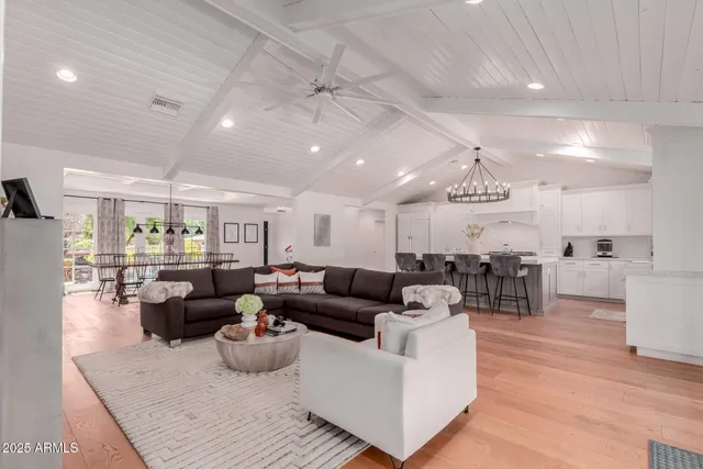 a living room with lots of furniture and kitchen view