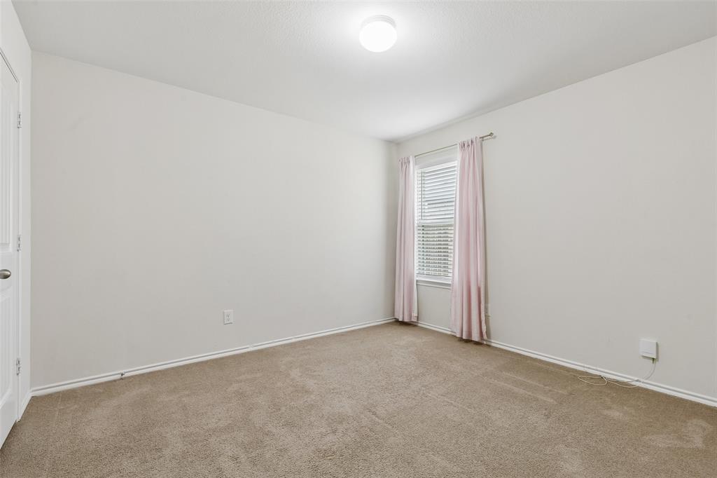 2850 Dusty Road Forney, TX 75126 - Photo 9 of 11 Neutral-toned room featuring a single window with blinds, light-colored walls, and carpet flooring
