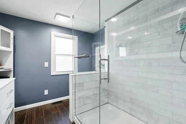 a view of a workspace with furniture and a window