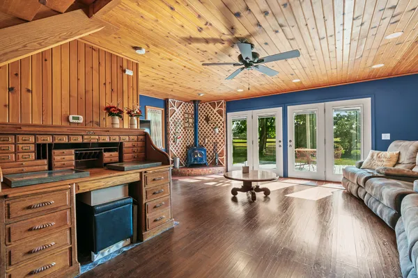 a kitchen with stainless steel appliances granite countertop wooden cabinets a sink and dishwasher a stove with wooden floor