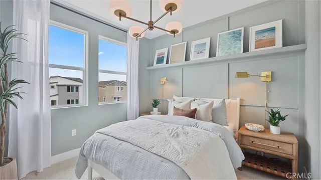 a bedroom with a large bed and a chandelier