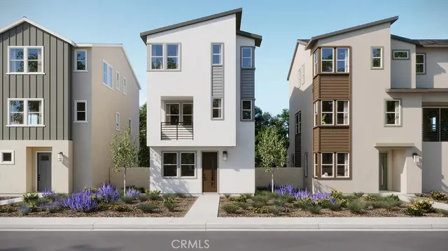 a front view of a multi story building with yard